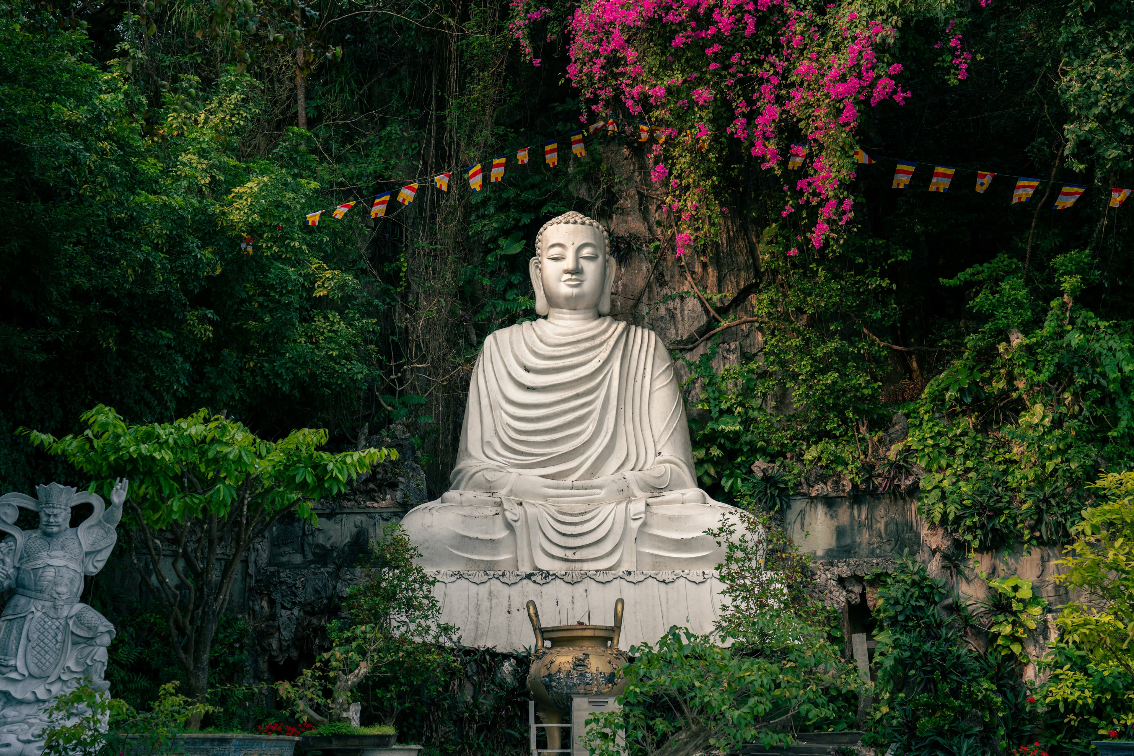 Buddhist garden with flowers and prayer flags